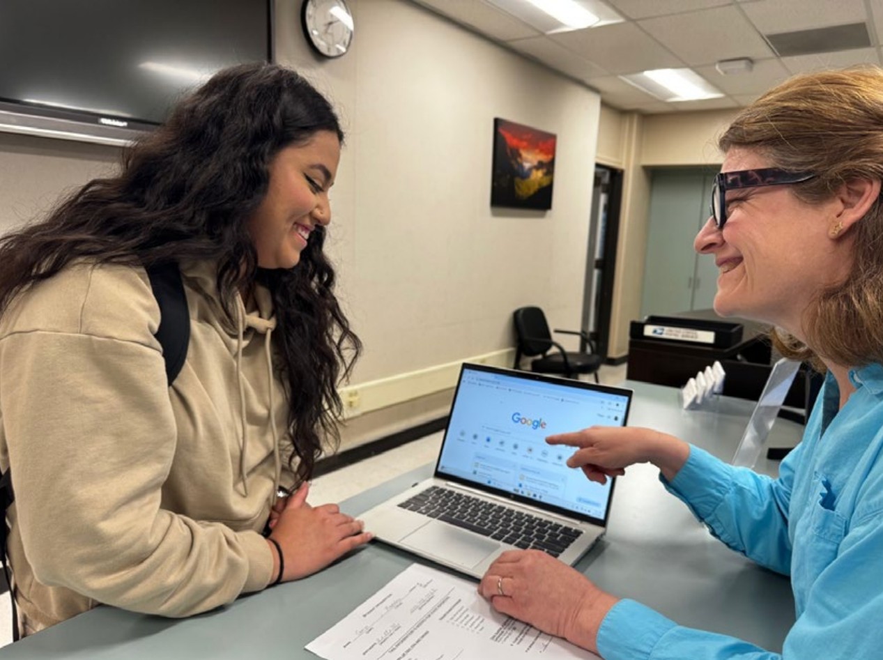 Two women looking at a laptop